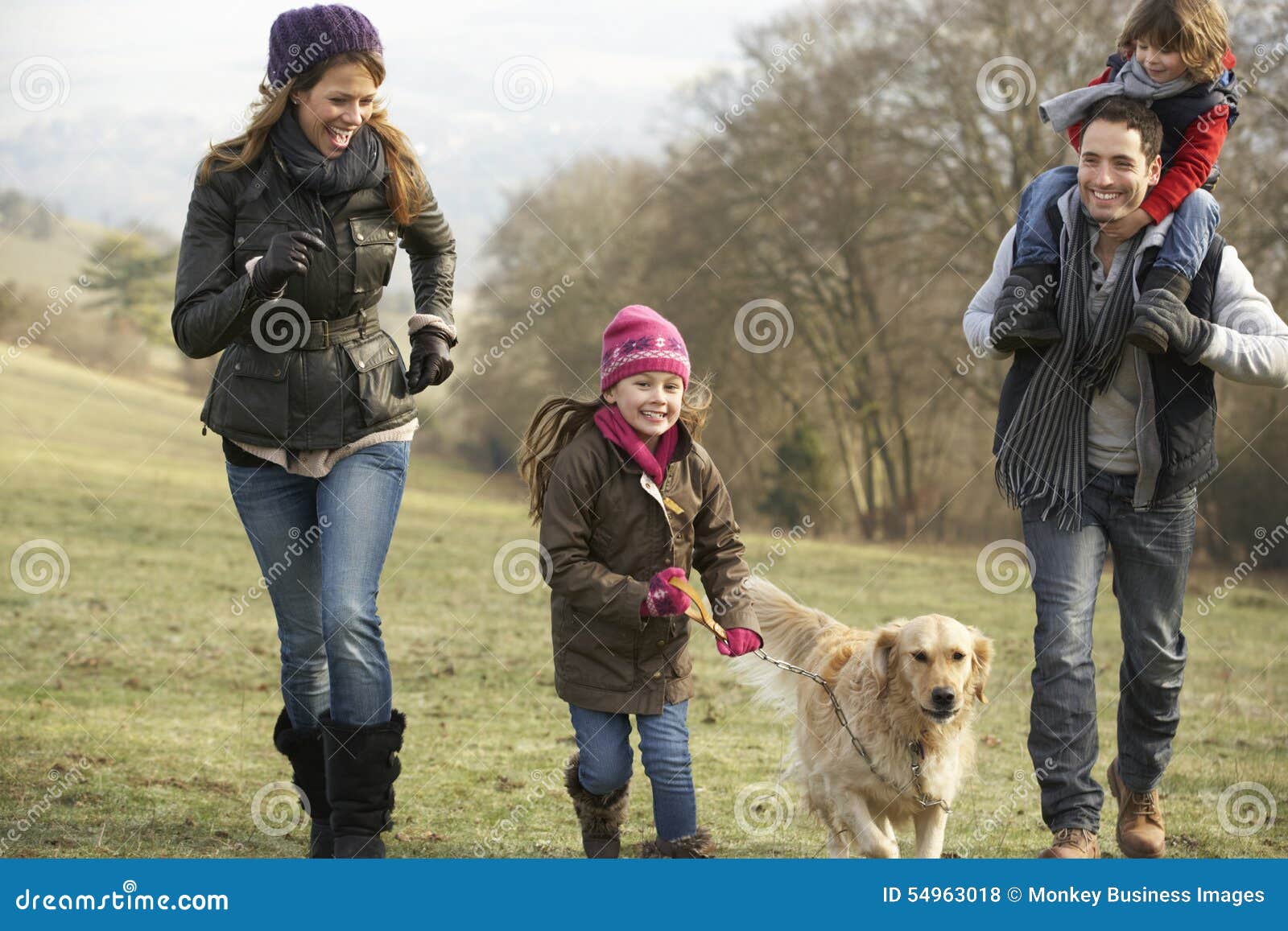 family and dog on country walk in winter