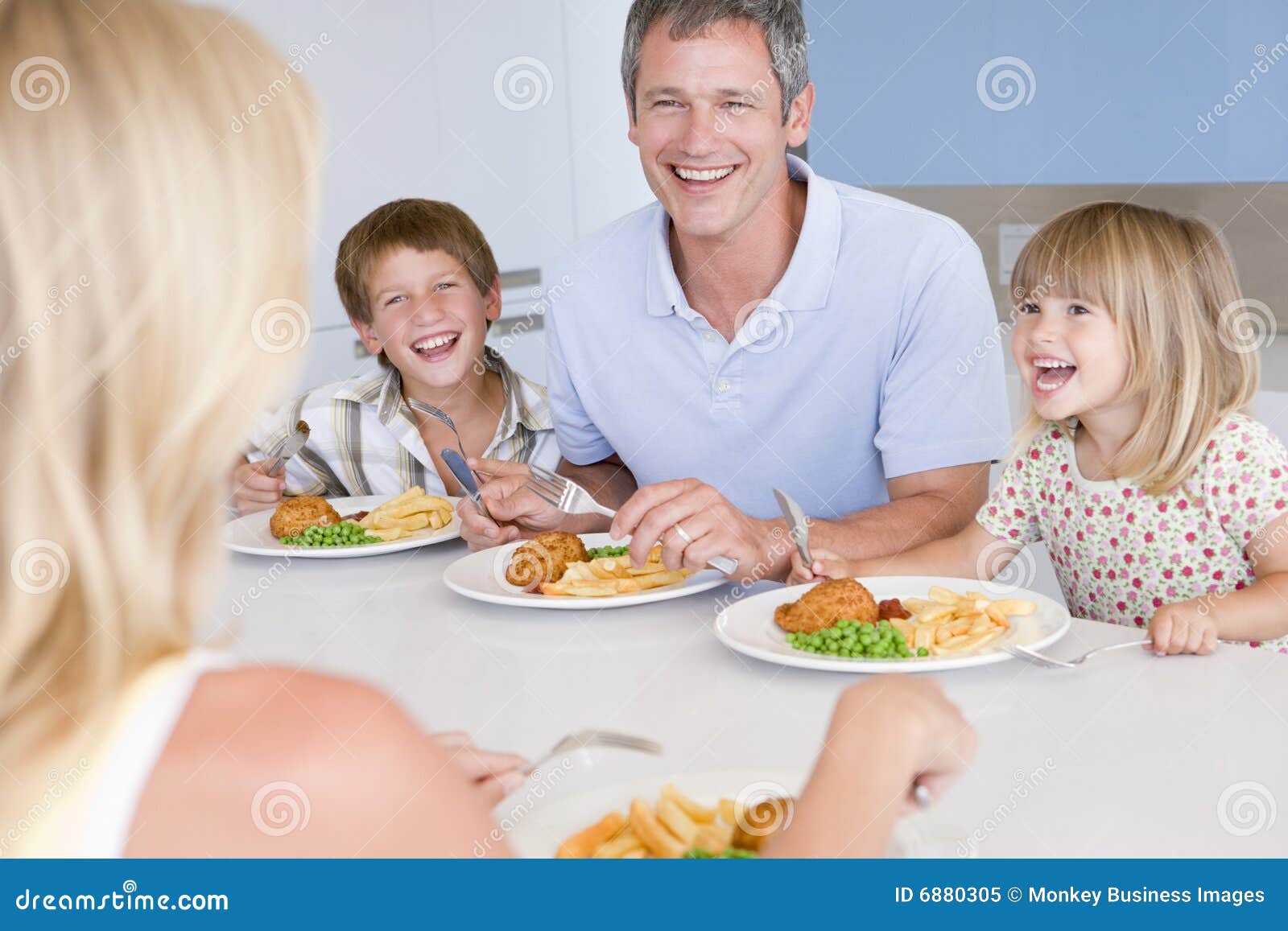 Family Eating a Meal,mealtime Together Stock Image - Image of adult