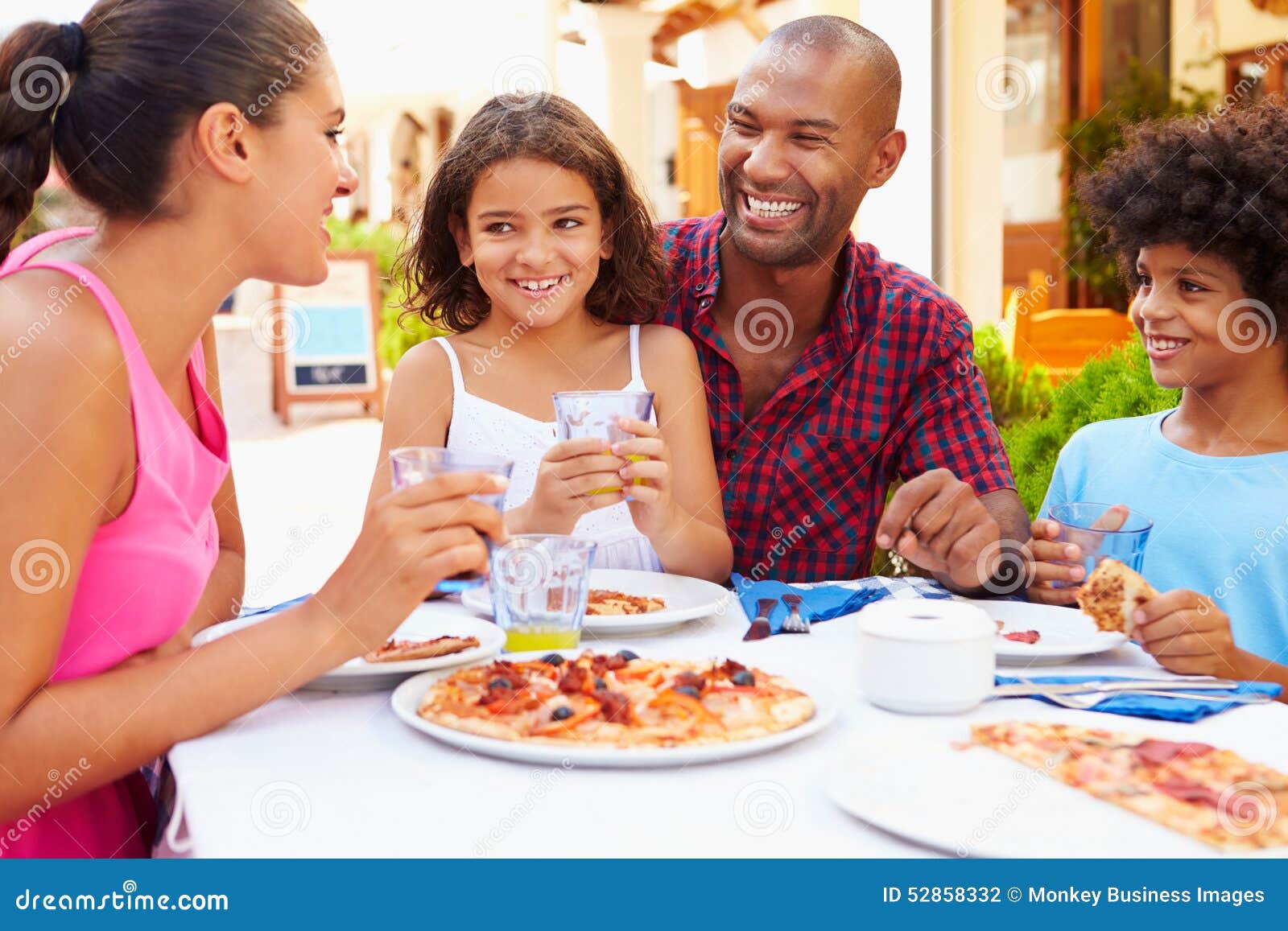Family Eating Meal at Outdoor Restaurant Together Stock Photo - Image