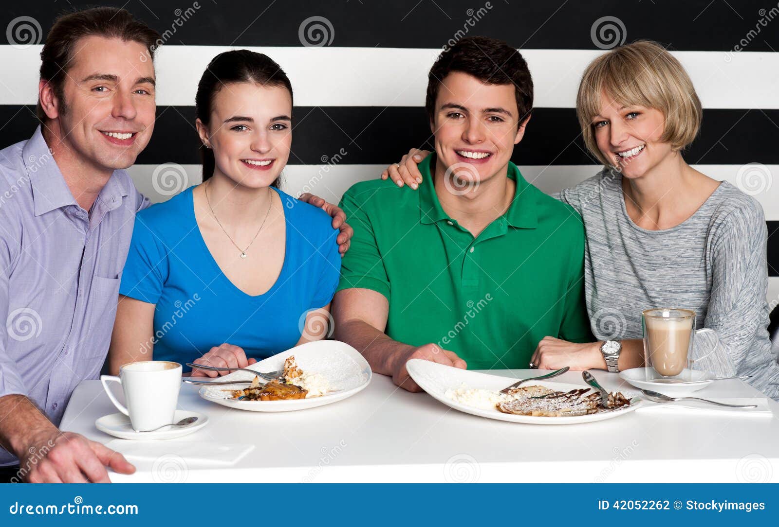 Family Enjoying Dinner at a Restaurant Stock Photo - Image of coffee