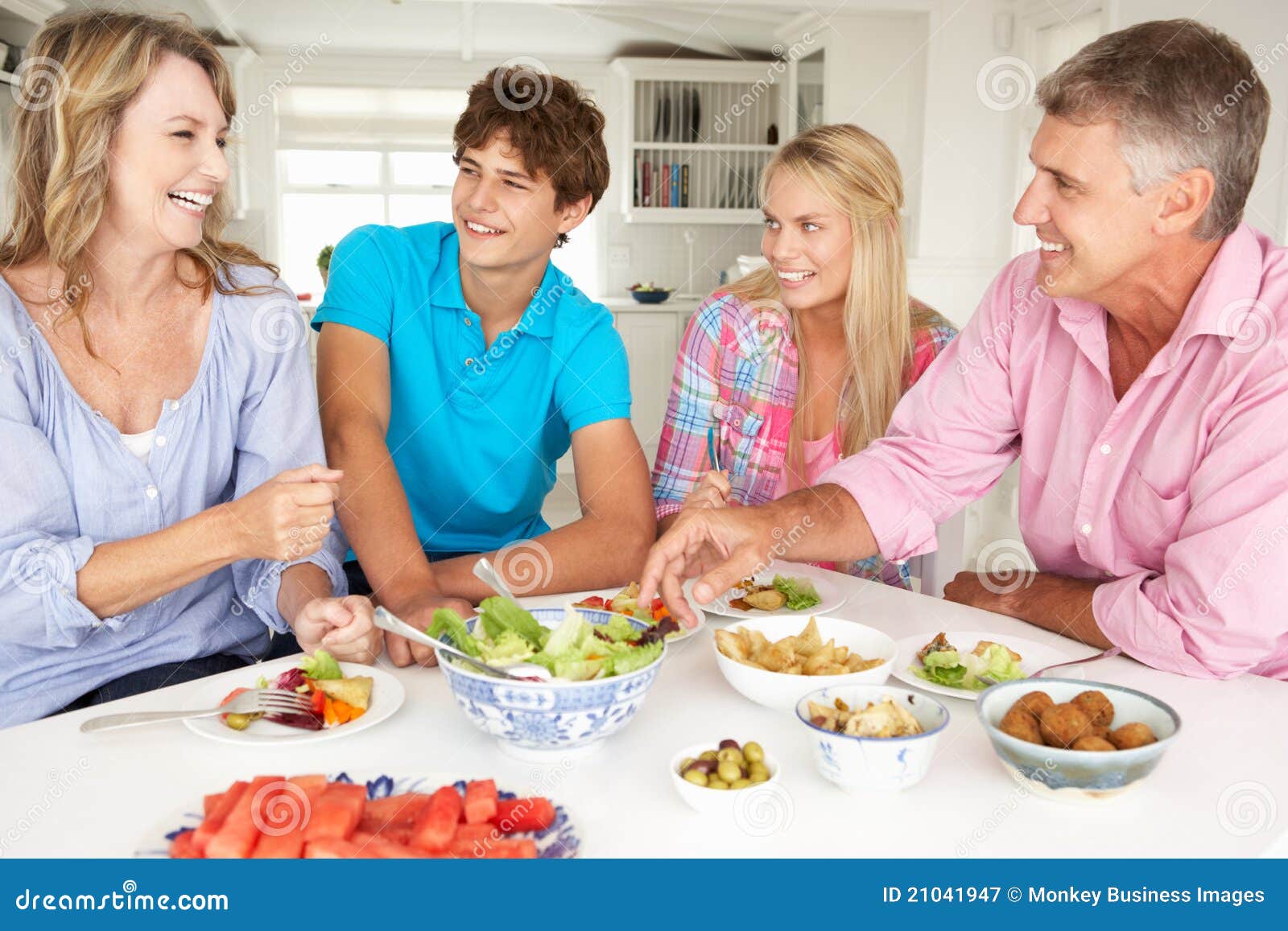 Family Enjoying Meal at Home Stock Image - Image of female, food: 21041947