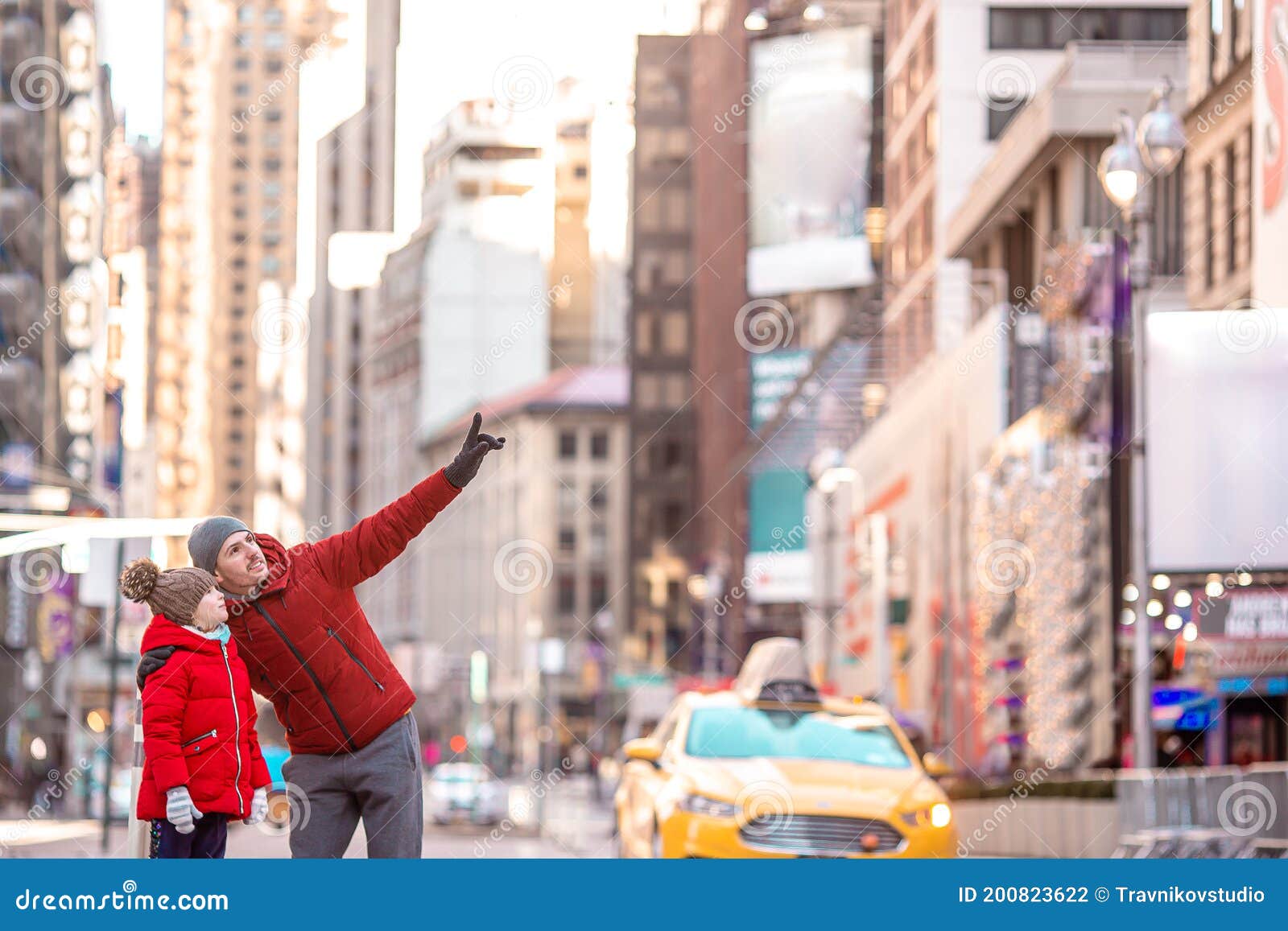 family of father and little kid on times square during their vacation in new york city