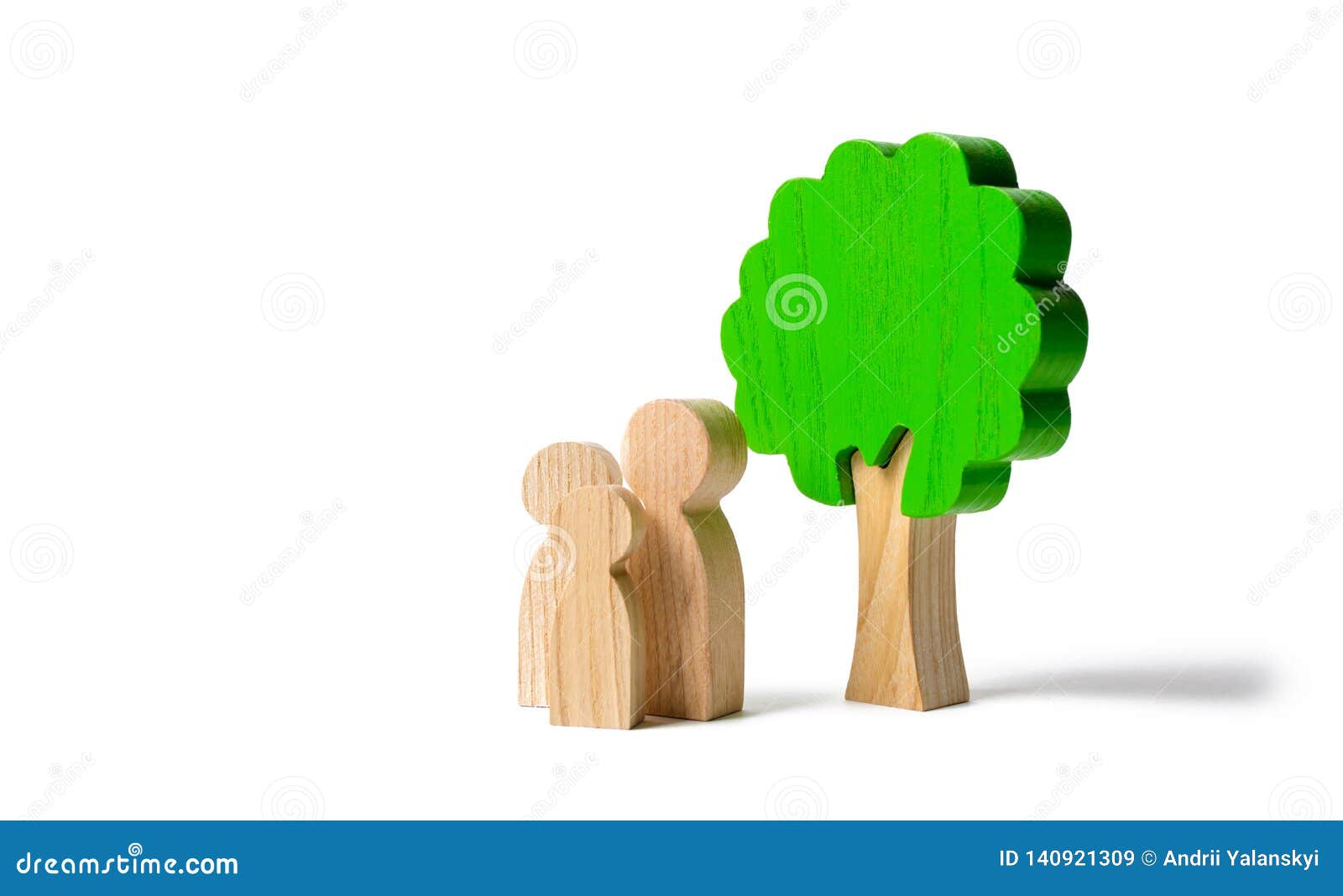 family figures are standing near the tree on an  background. pastime with family, kinship and parenting. instilling good