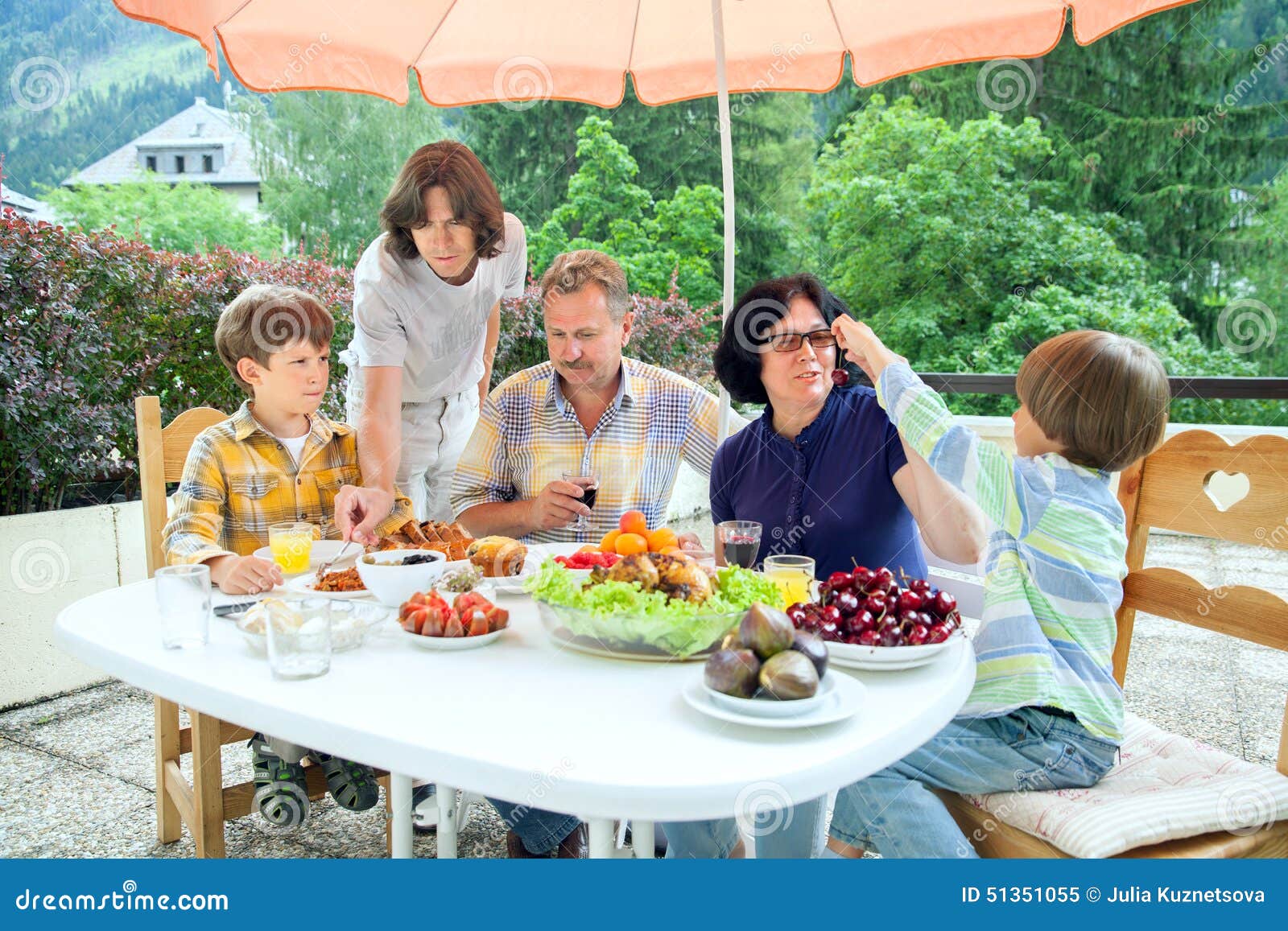 The Family from Five Persons Have Got Dinner on Summer Terrace Stock