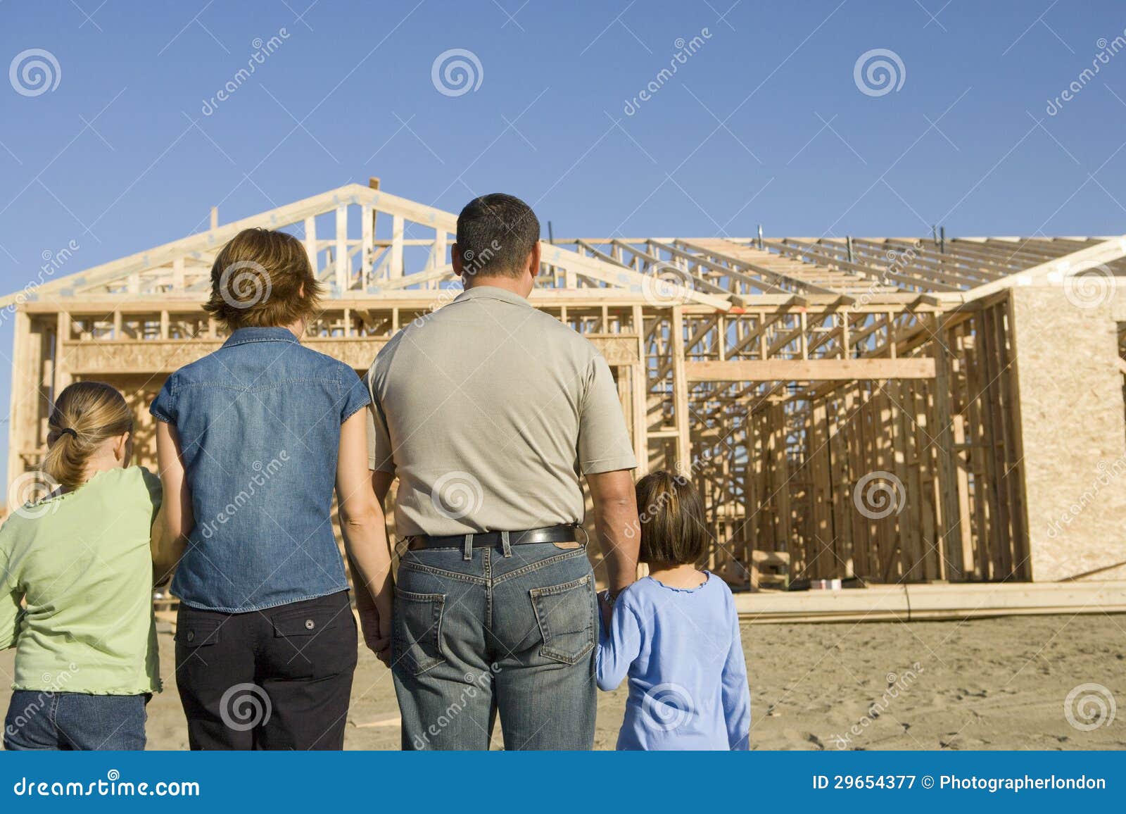 family in front of incomplete house