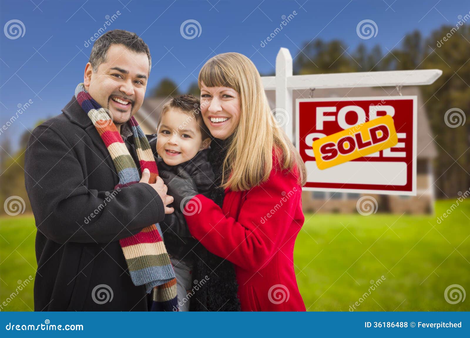Family in Front of Sold Real Estate Sign and House Stock Photo - Image ...