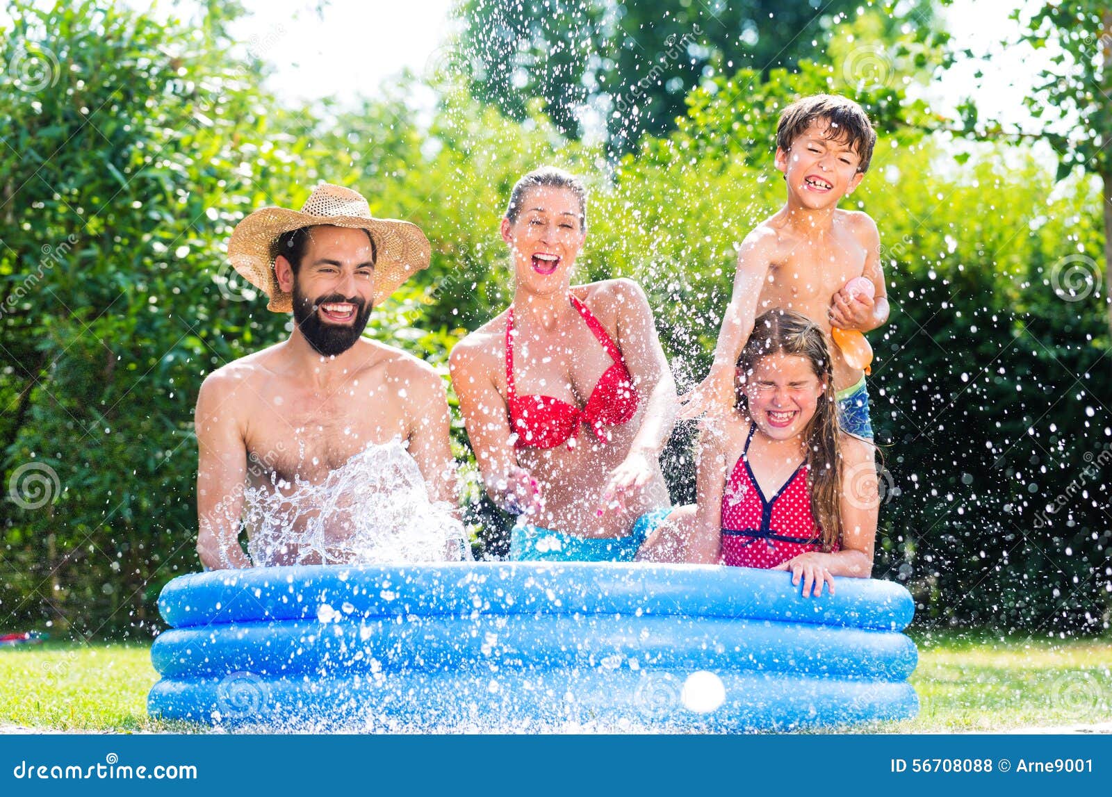 family-garden-pool-cooling-down-splashing-water-56708088.jpg