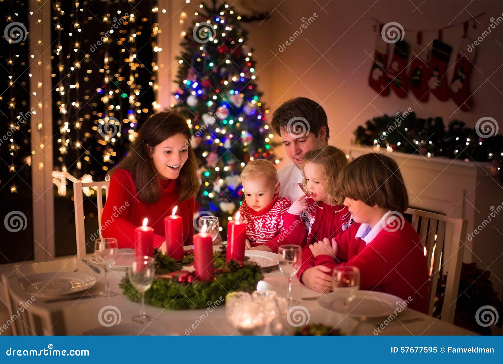 Family Having Christmas Dinner At Fire Place Stock Photo ...