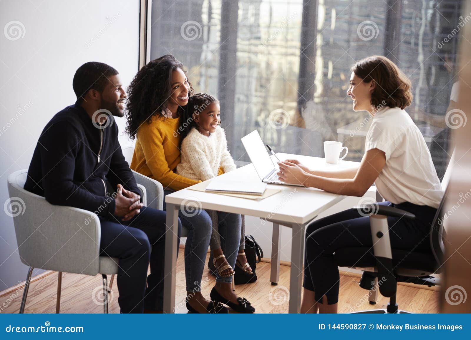 family having consultation with female pediatrician in hospital office