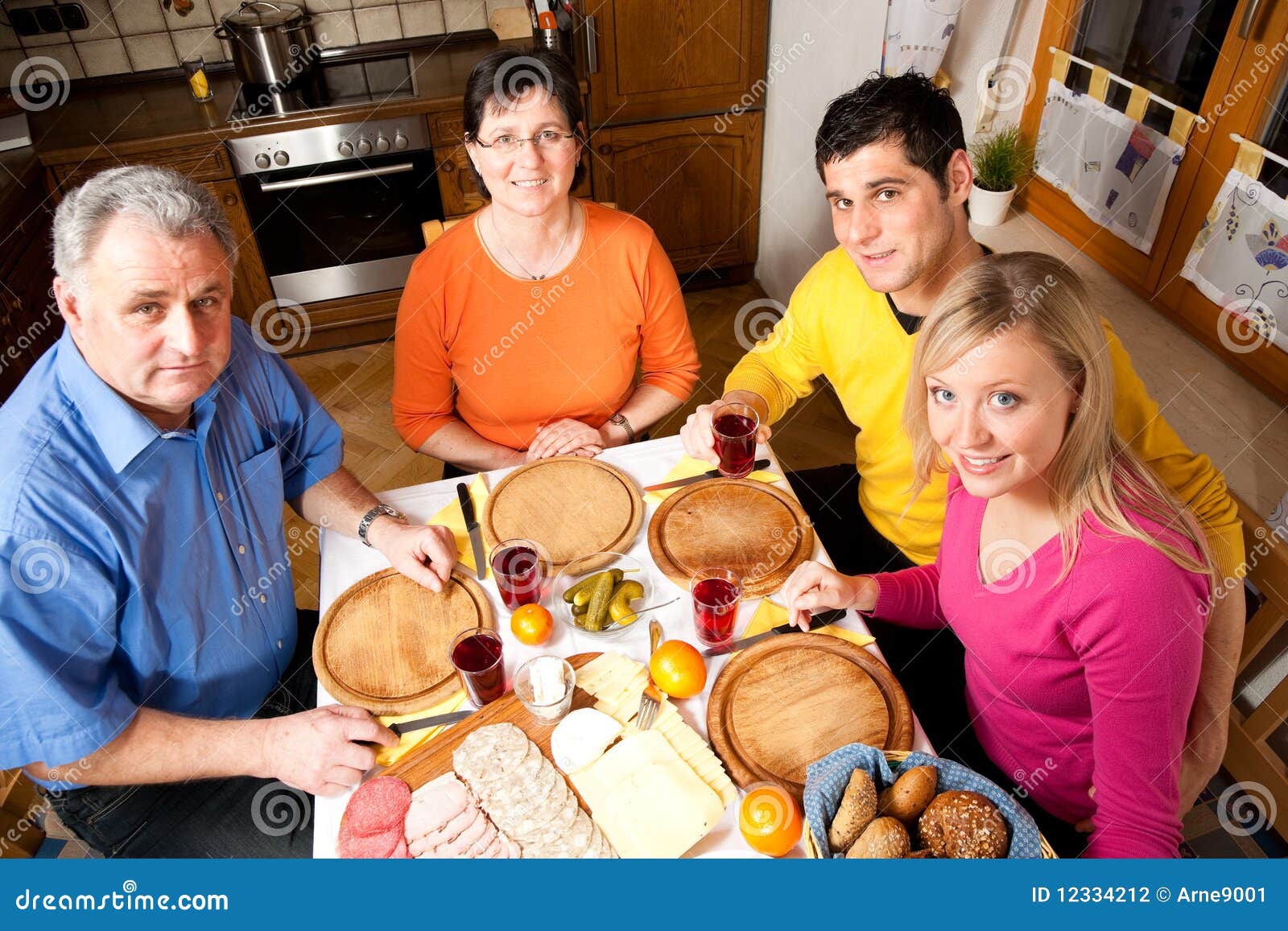 Family Having Hearty Dinner Stock Photo - Image of bread, meal: 12334212