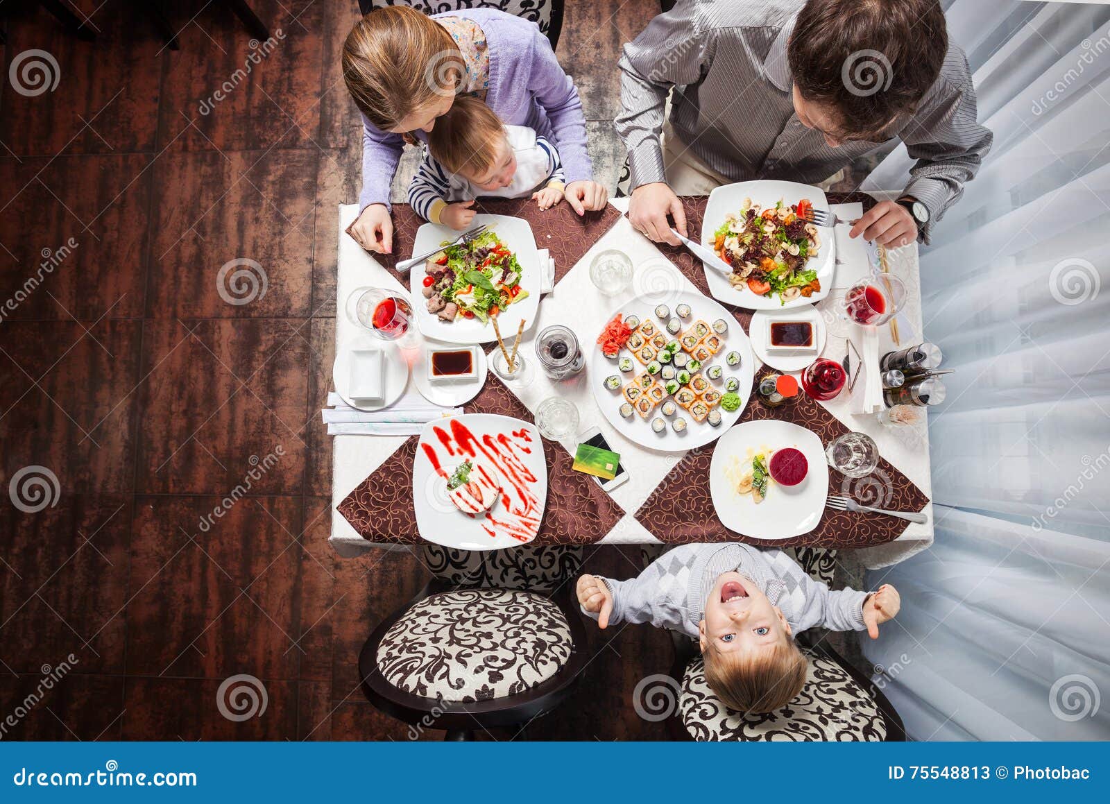 Family Having Meal at a Restaurant Stock Image - Image of girl, food