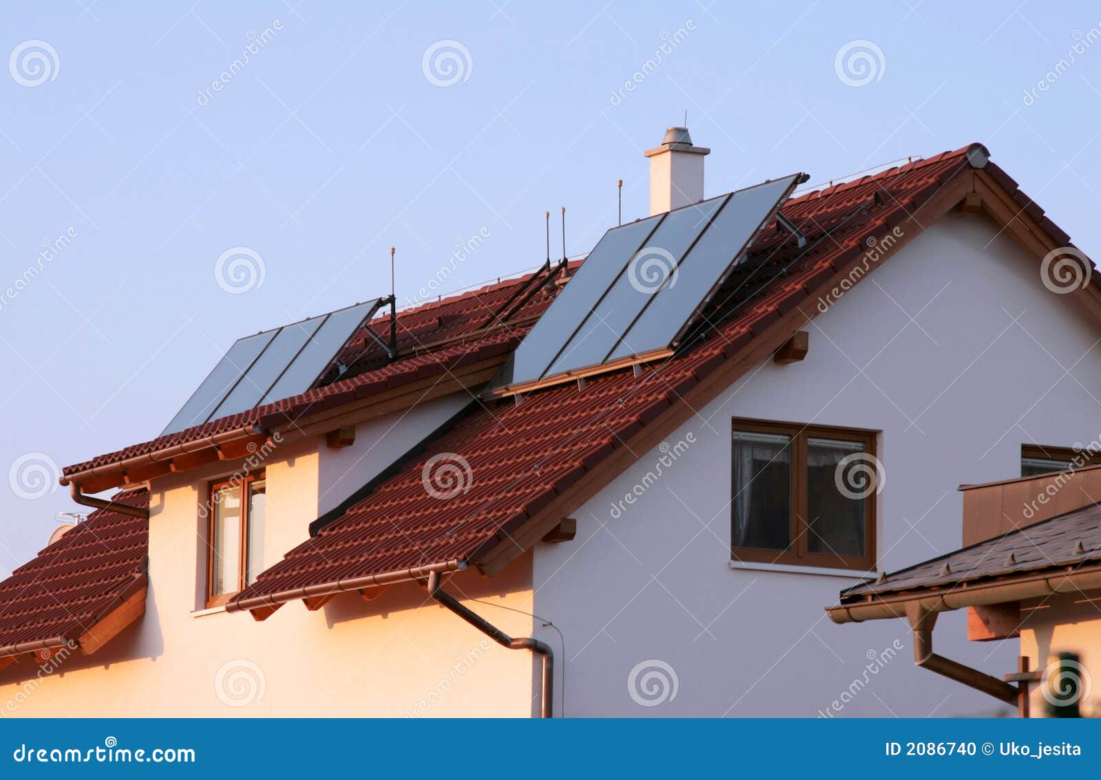 family house with solar panels on the roof for water heating