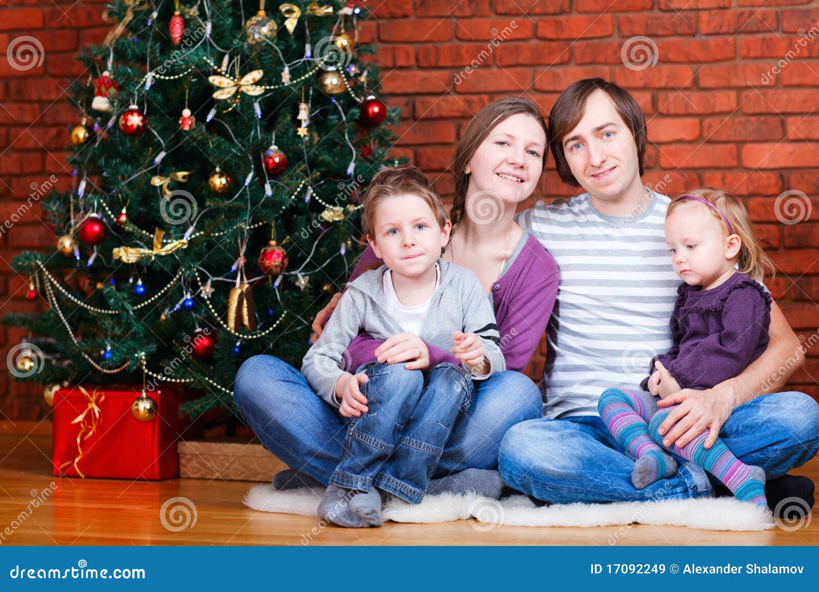 Family near Christmas tree stock image. Image of cheerful 17092249