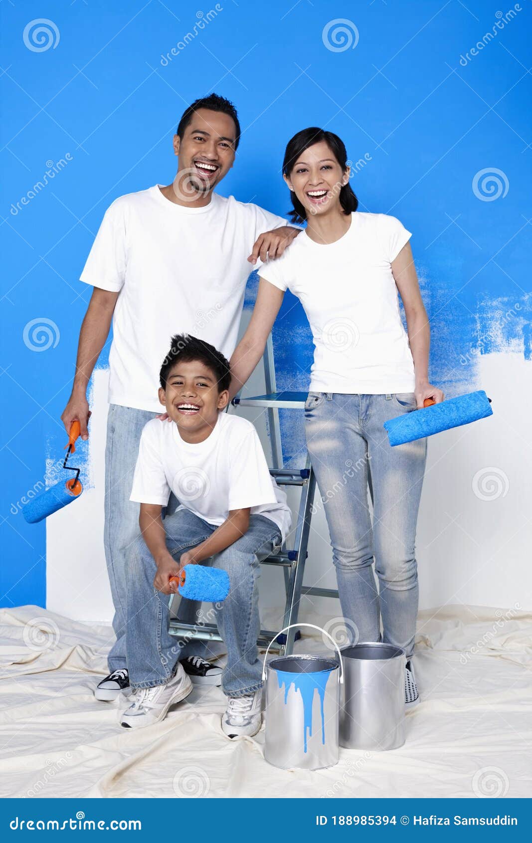 Family with Paint Rollers Getting Ready To Paint the Wall. Conceptual