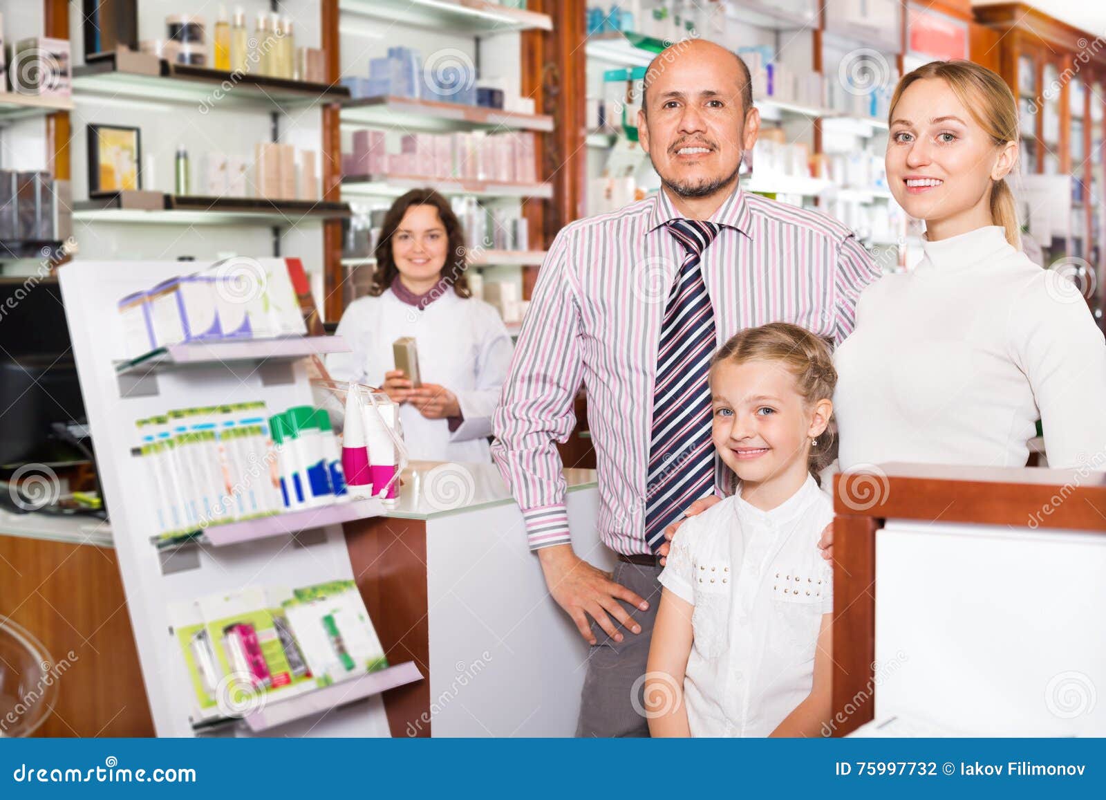 Family With A Kid In Pharmacy RoyaltyFree Stock Photography