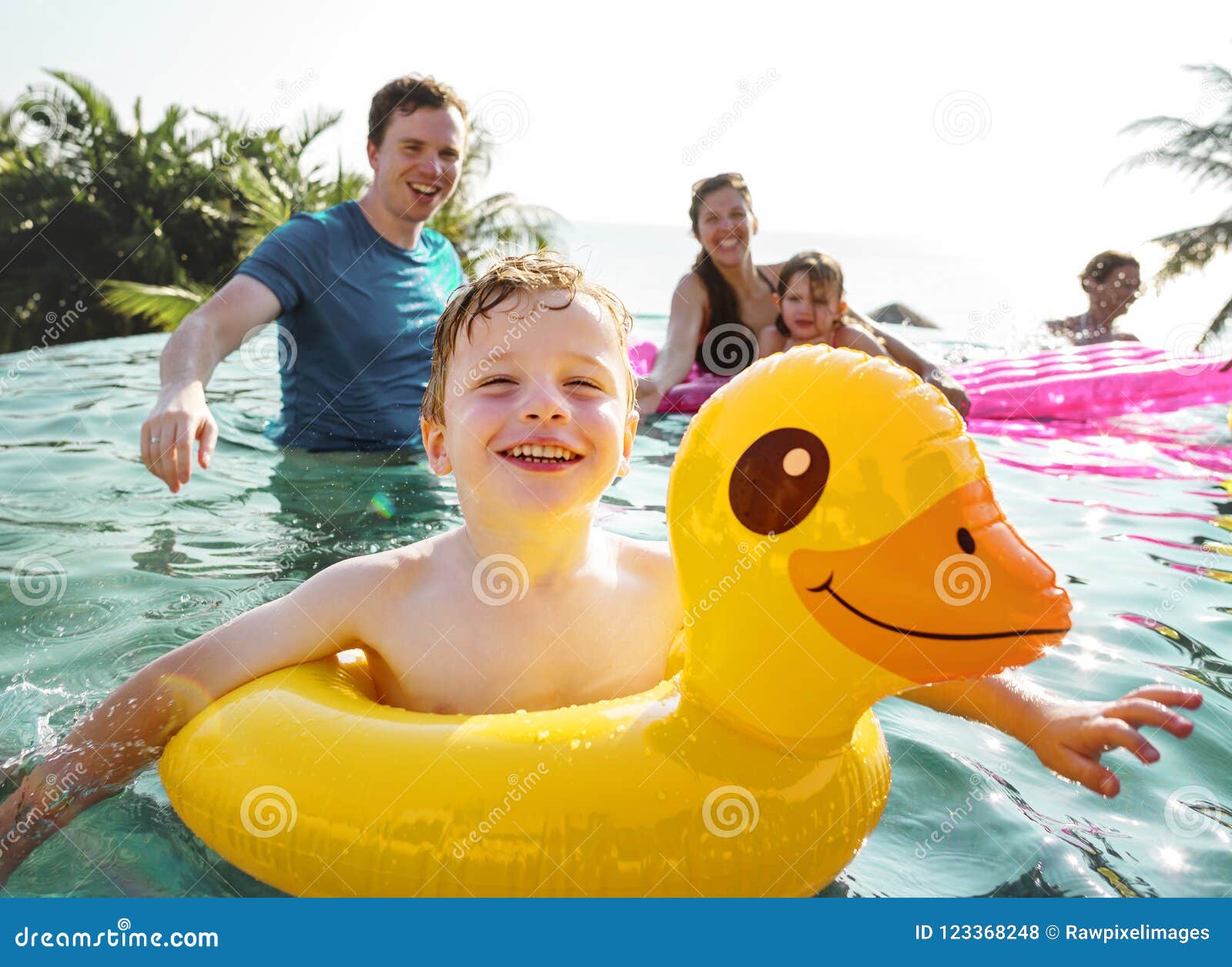 Family playing in a pool stock photo. Image of lifestyle 123368248