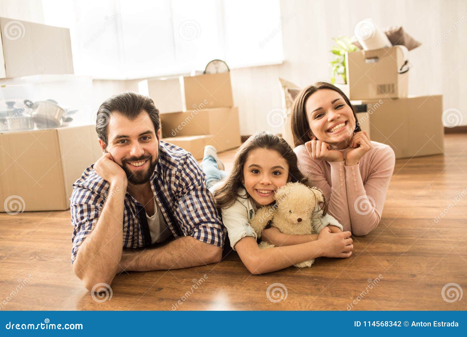 Family Portrait Of Three People Lying On The Floor Man Woman And