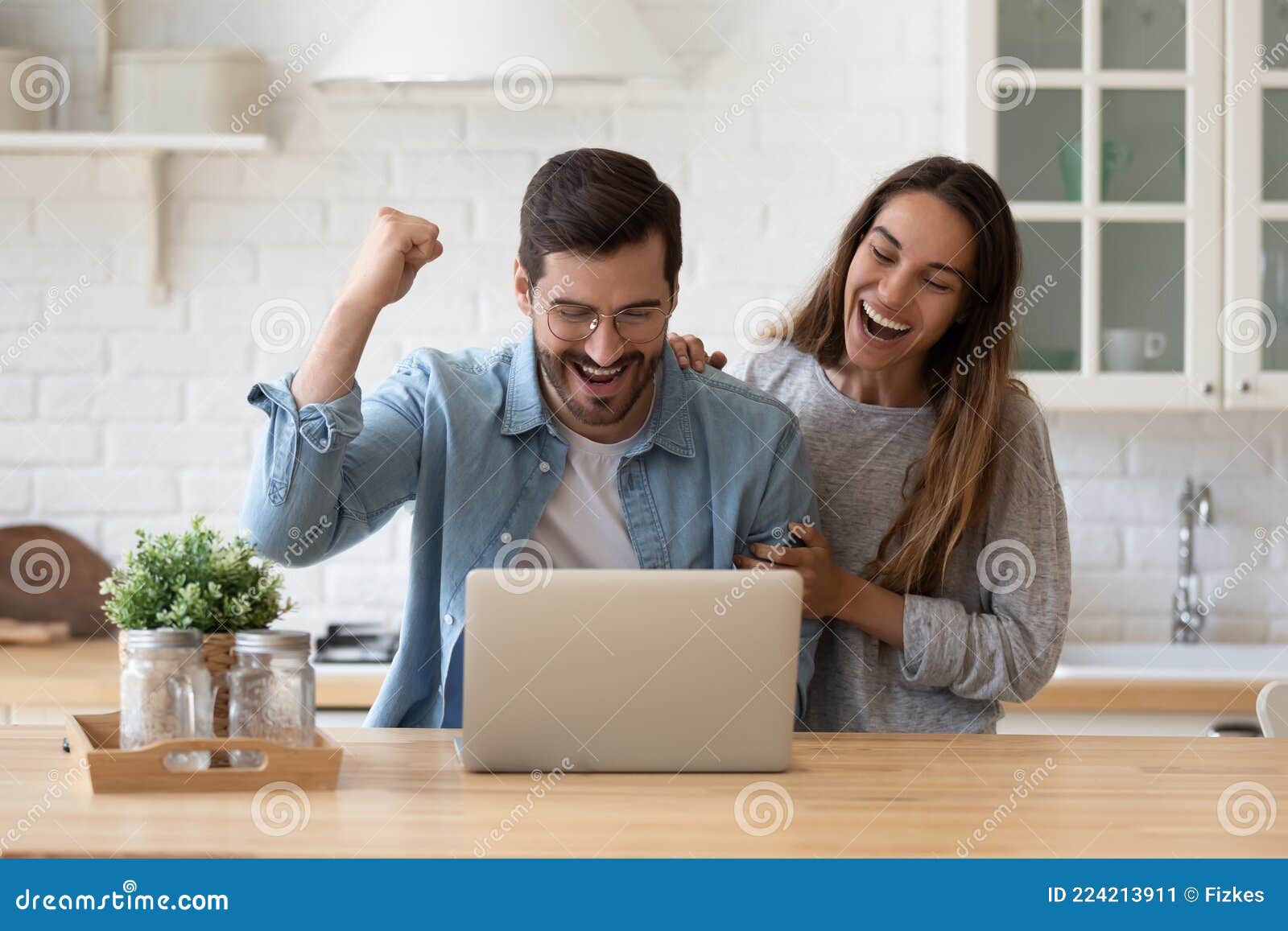 family reading e-mail from bank on laptop celebrate loan approval