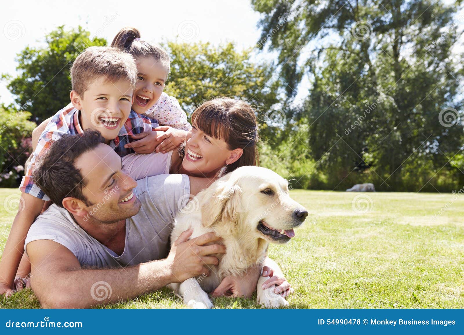 family relaxing in garden with pet dog