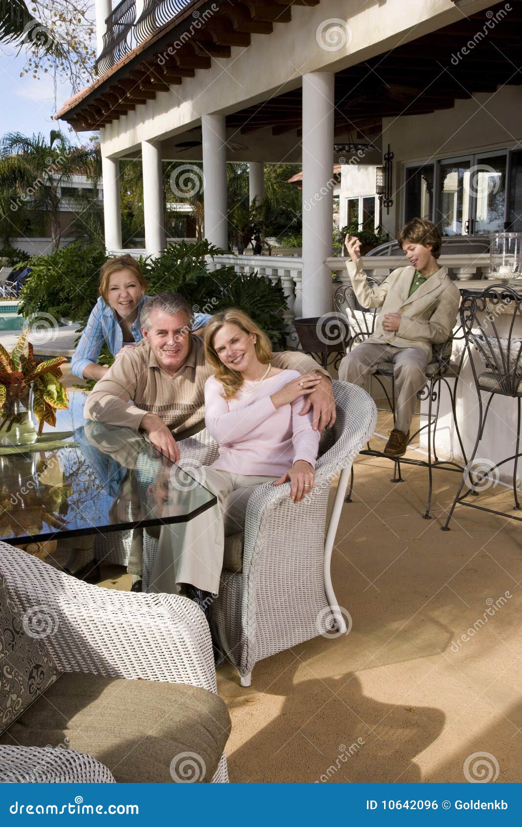 Family Relaxing On Outdoor Patio Stock Photo - Image: 10642096