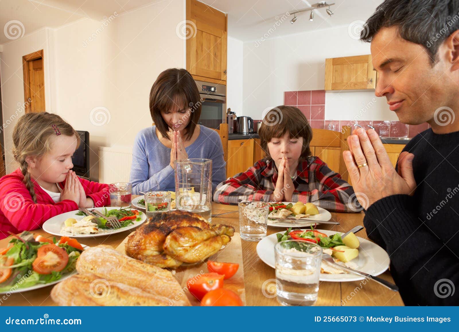 Family Saying Grace Before Eating Lunch Stock Image ...