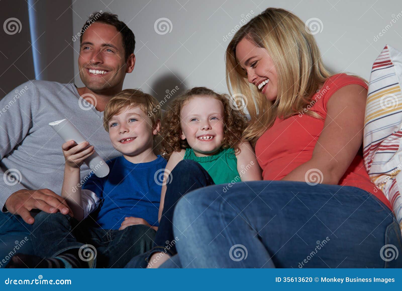 Family Sitting on Sofa Watching TV Together Stock Photo Image of