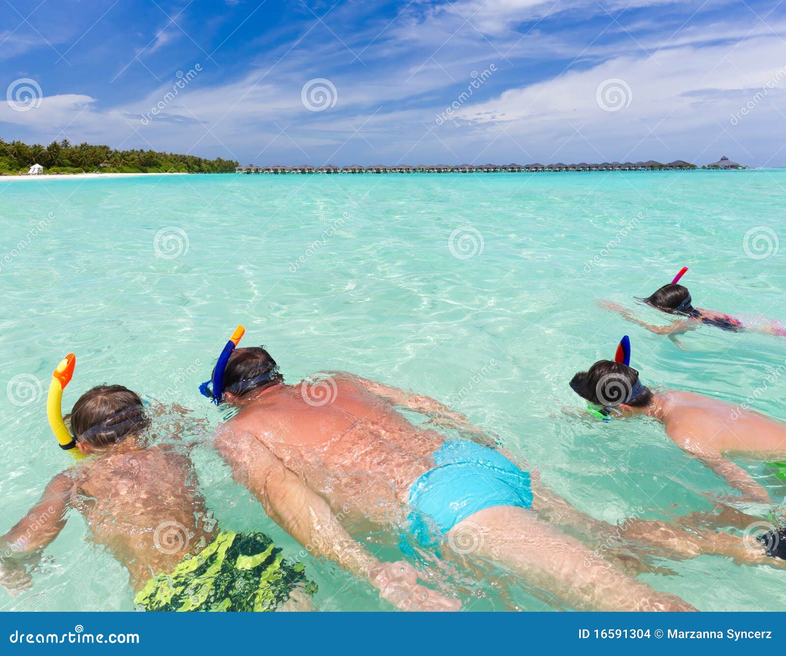 Father And Son Snorkels Through Tropical, Turquoise Waters, Aerial View