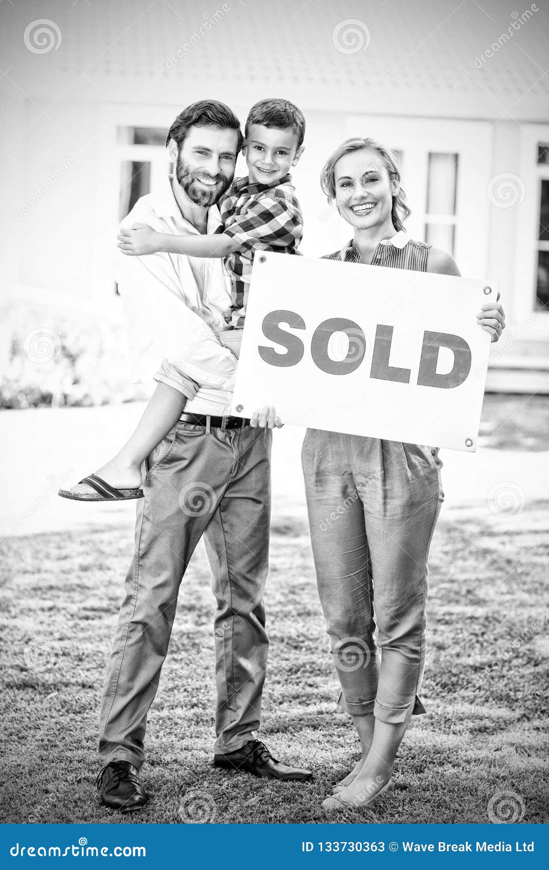 Family Standing Outside Home with Sold Sign Stock Image - Image of ...