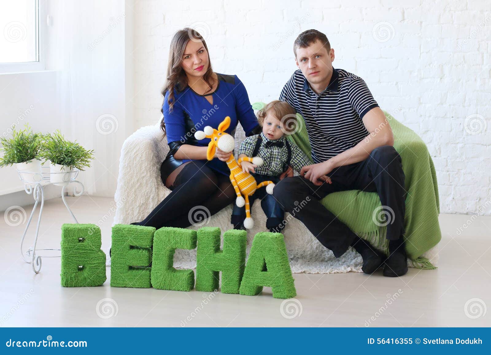 Family of Three Sit on White Couch in Room Stock Image Image of
