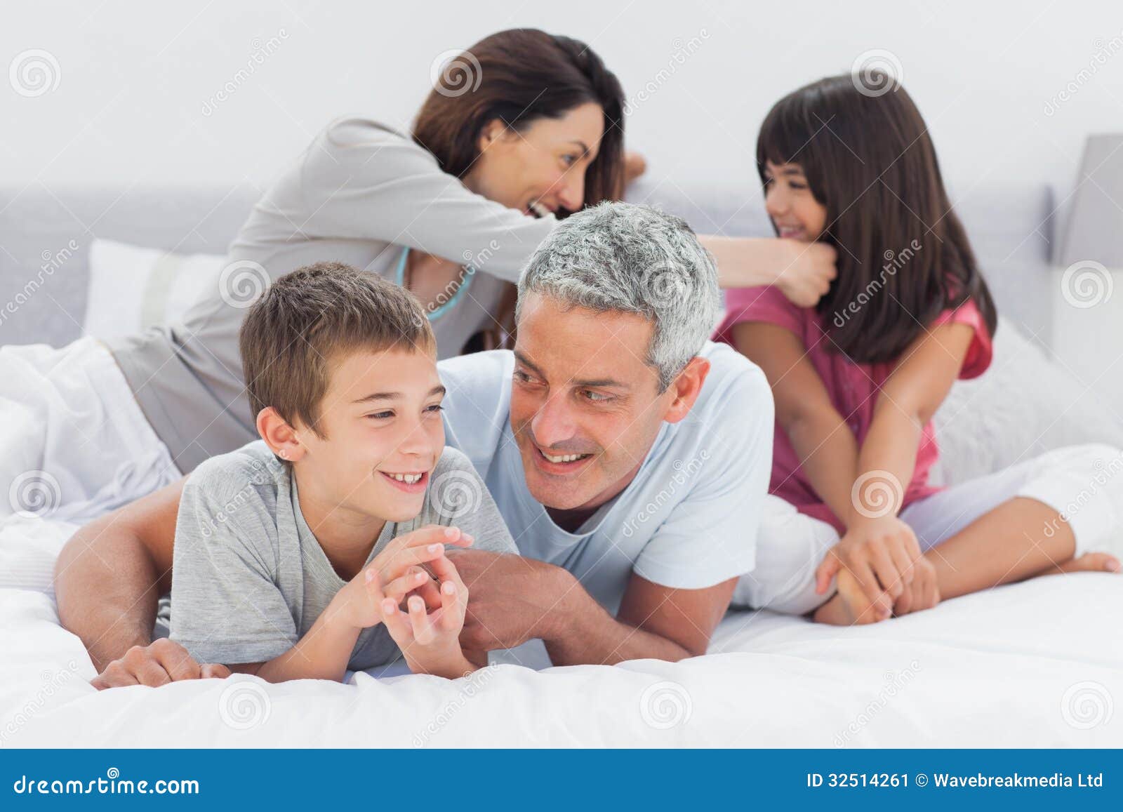 Family together on bed stock image. Image of home, brown 32514261