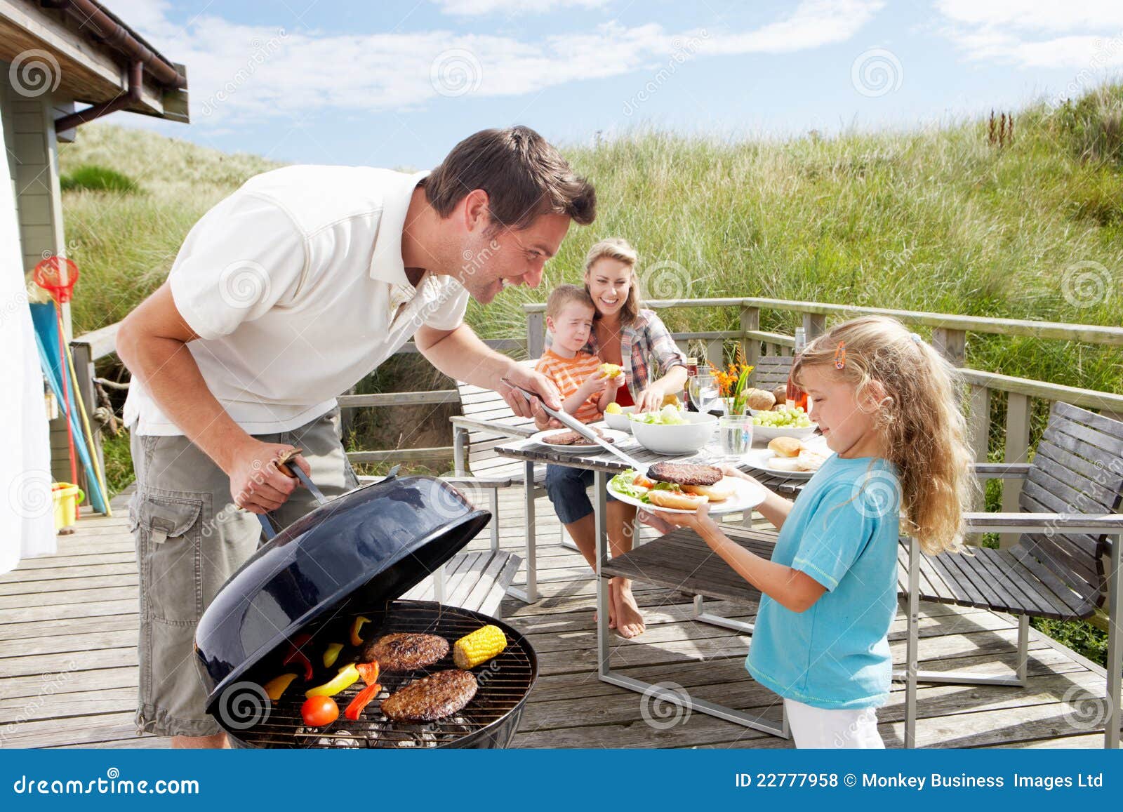 family on vacation having barbecue