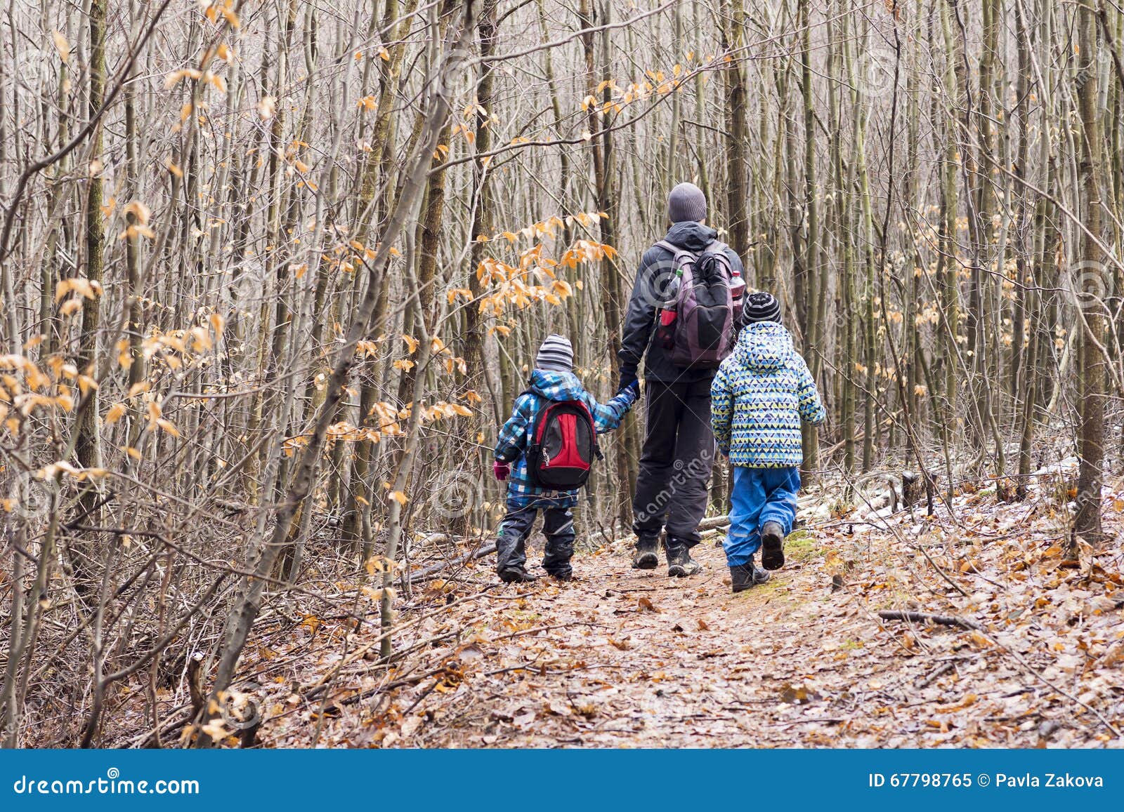 family walking in forest