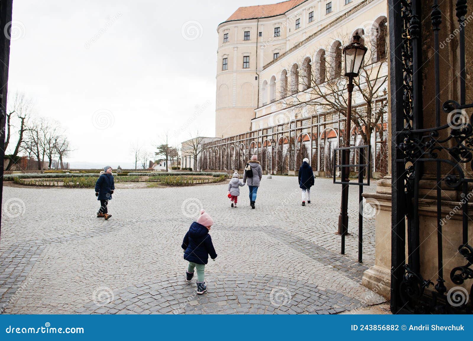 family walking at historical mikulov castle, moravia, czech republic. old european town