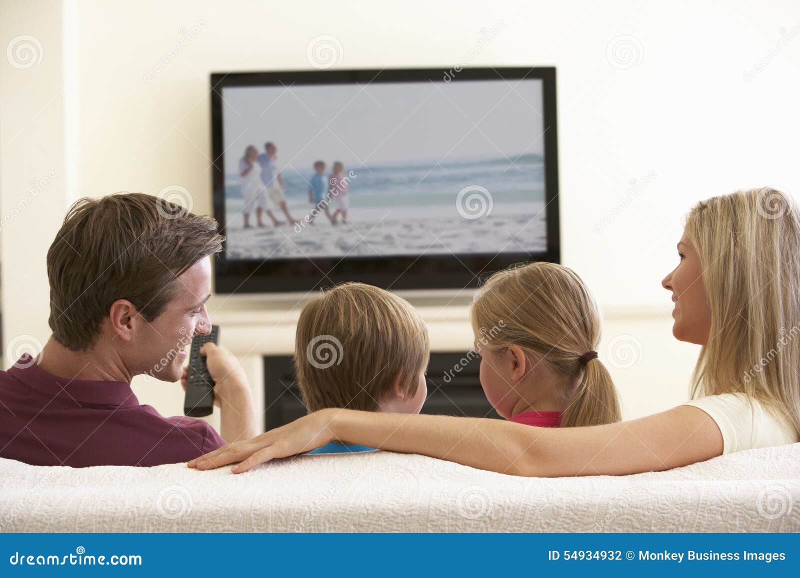 family watching widescreen tv at home