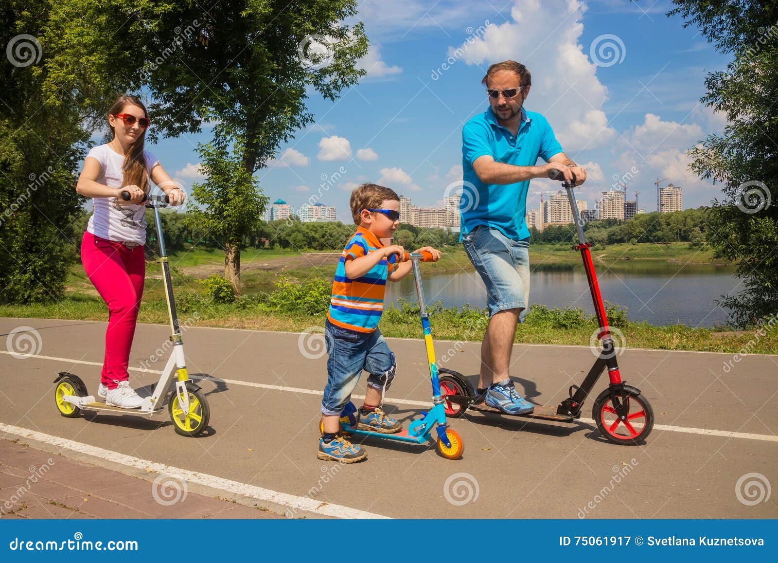 Family with Young Son Riding on Scooter Stock Image - Image of paved