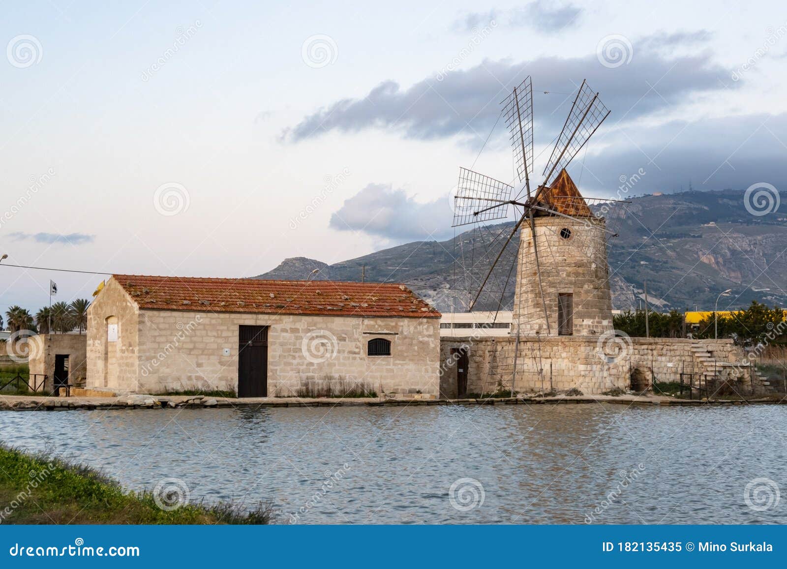 famous ancient windmill of riserva naturale saline visitor centre in trapani, sicily. it is producing sea salt using evaporation