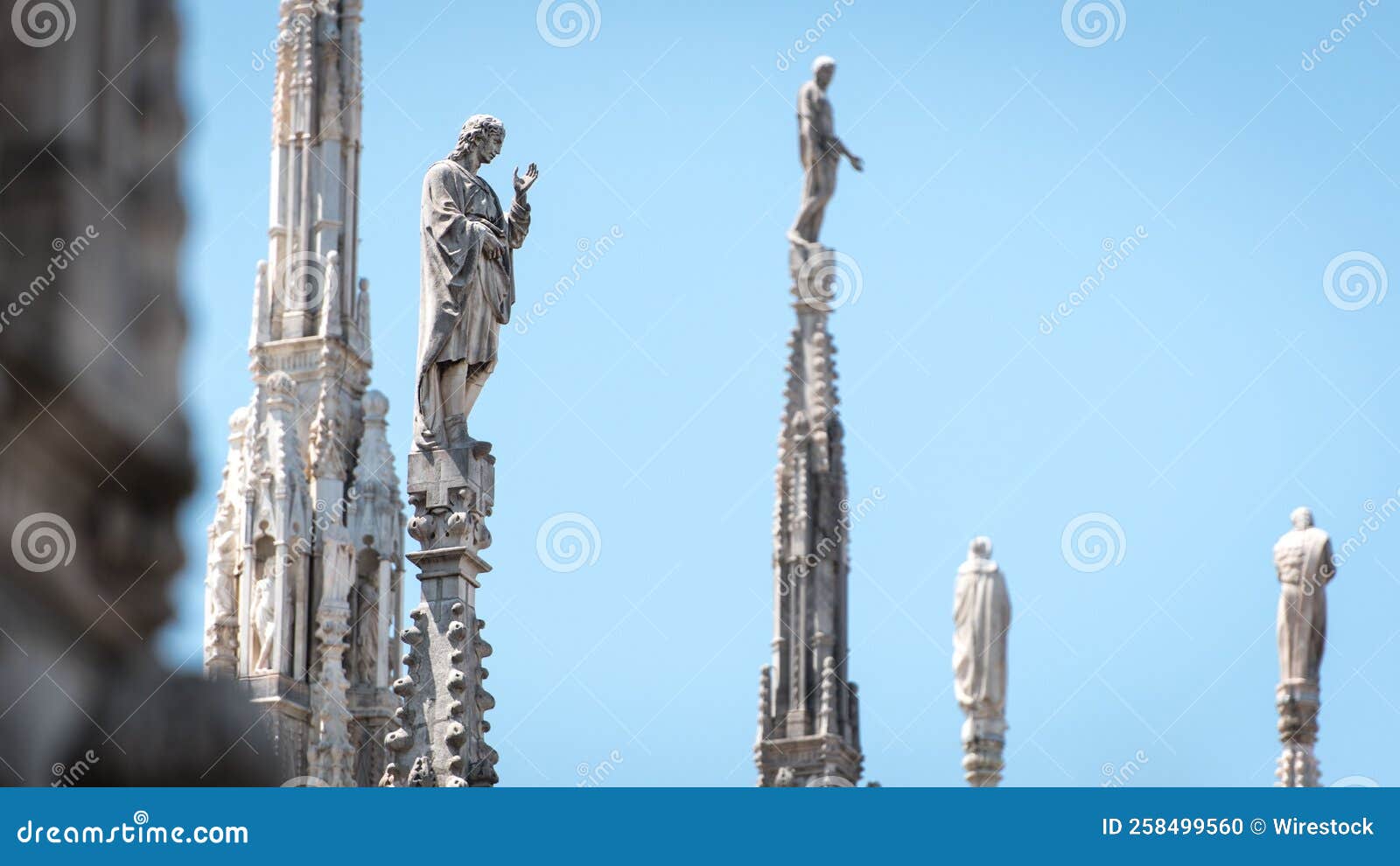 Famous Milan Cathedral with Statues Against a Blue Sky Stock Photo