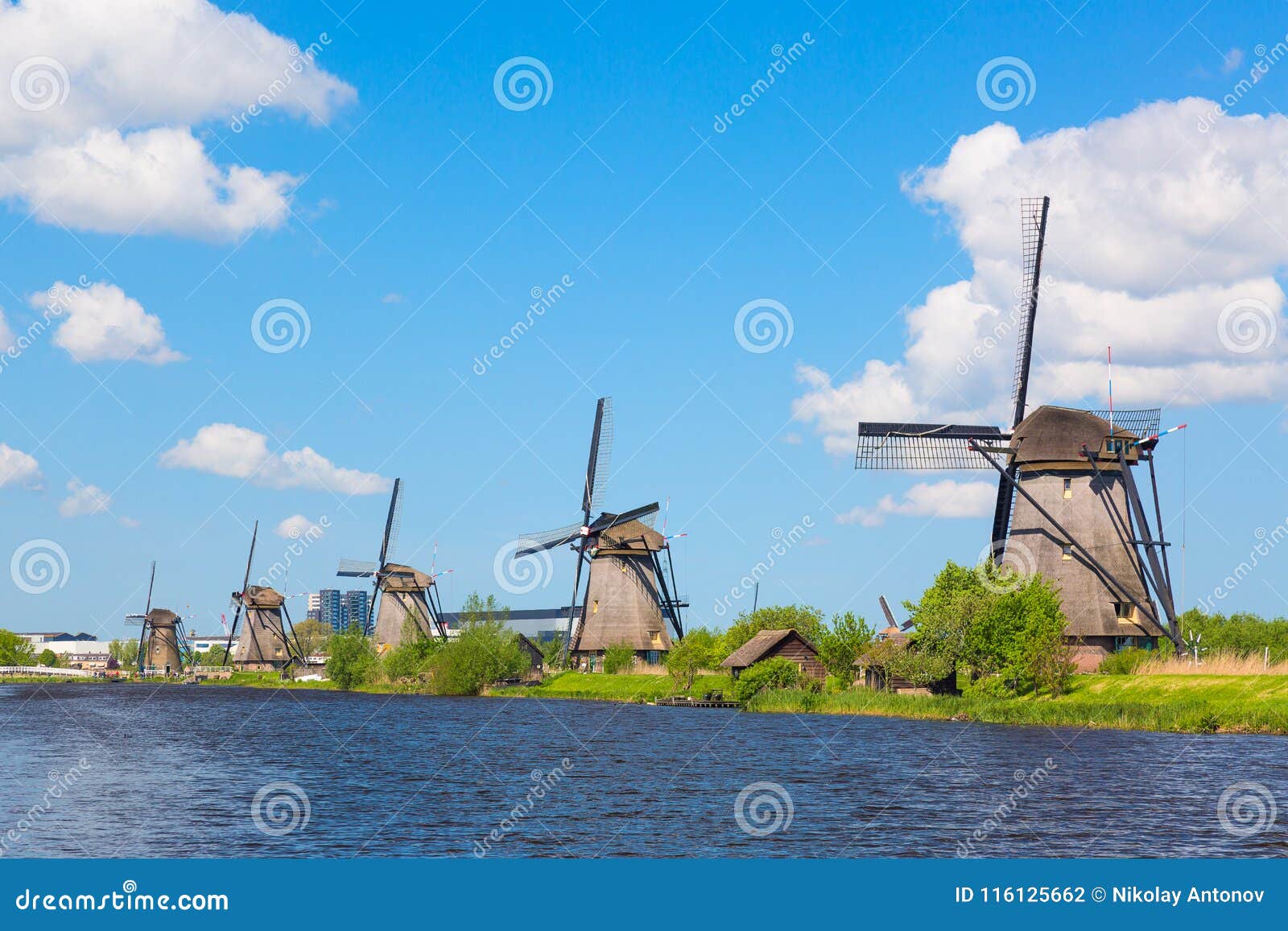 famous windmills in kinderdijk village in holland. colorful spring landscape in netherlands, europe. unesco world heritage and fam