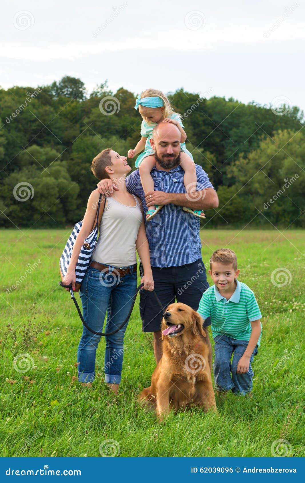 Família nova bonita com seu cão de estimação, golden retriever