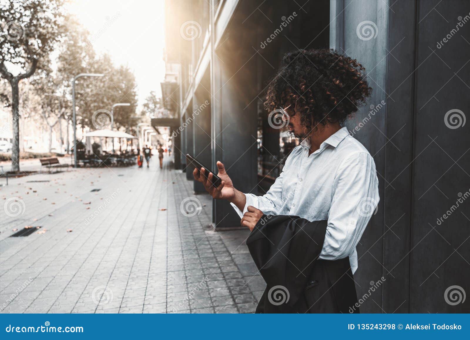 Fancy Curly Bearded Guy with Cellphone Outdoors Stock Photo - Image of