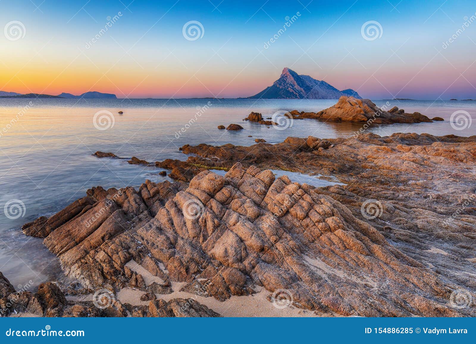 fantastic azure water with rocks near beach porto taverna at sunset
