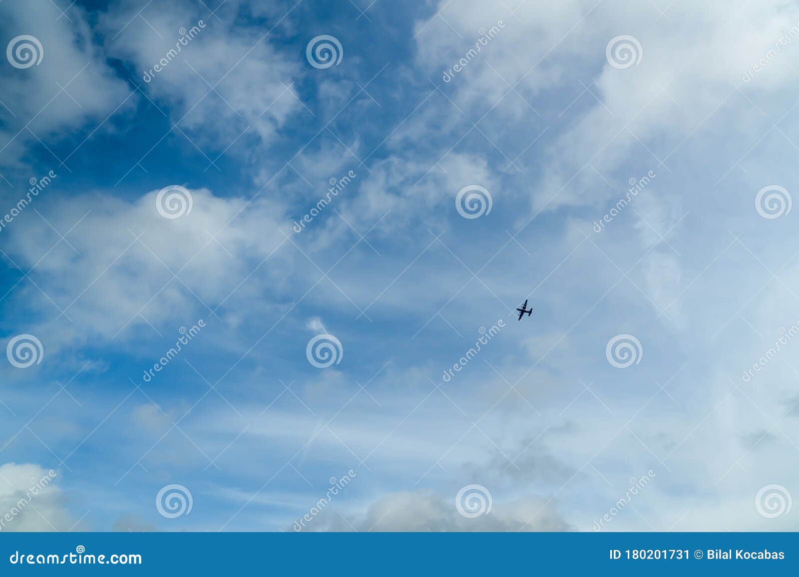 far view of silhouette four engine propeller airplane on blue sky