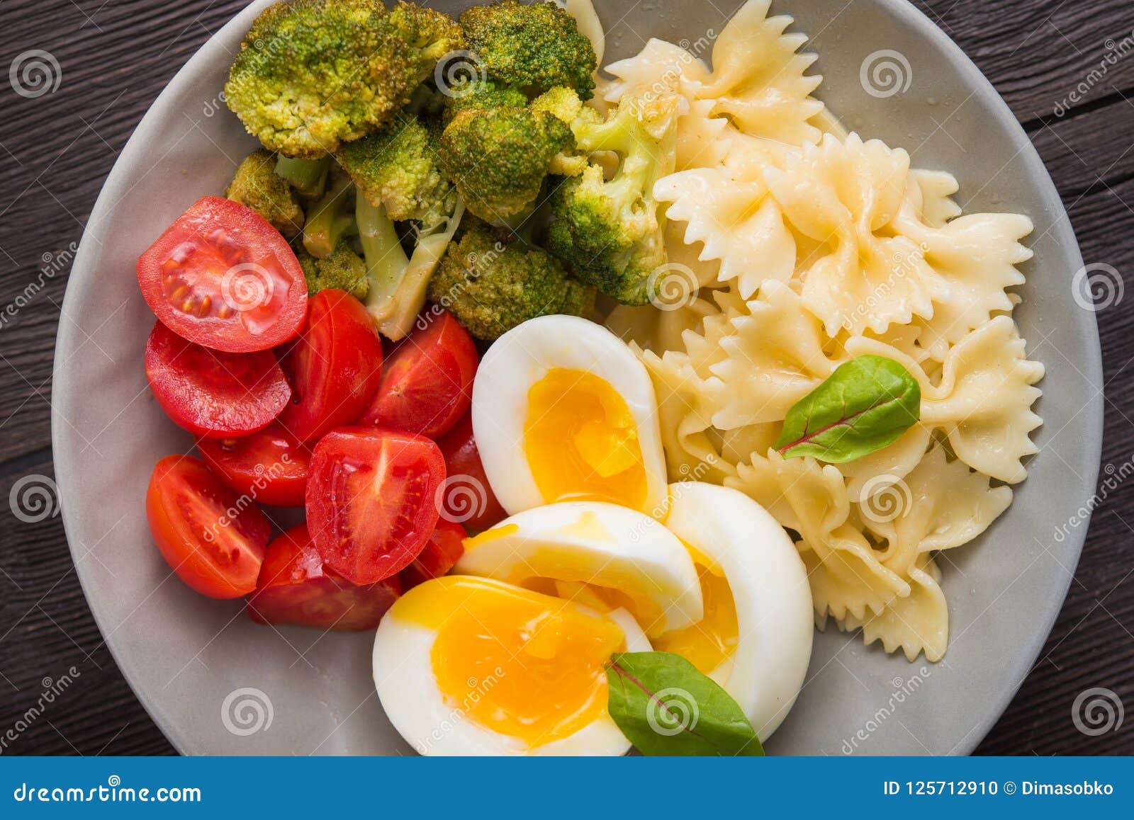 Farfalle Pasta with Egg, Tomato and Broccoli in a Bowl Stock Photo - Image  of dinner, table: 125712910