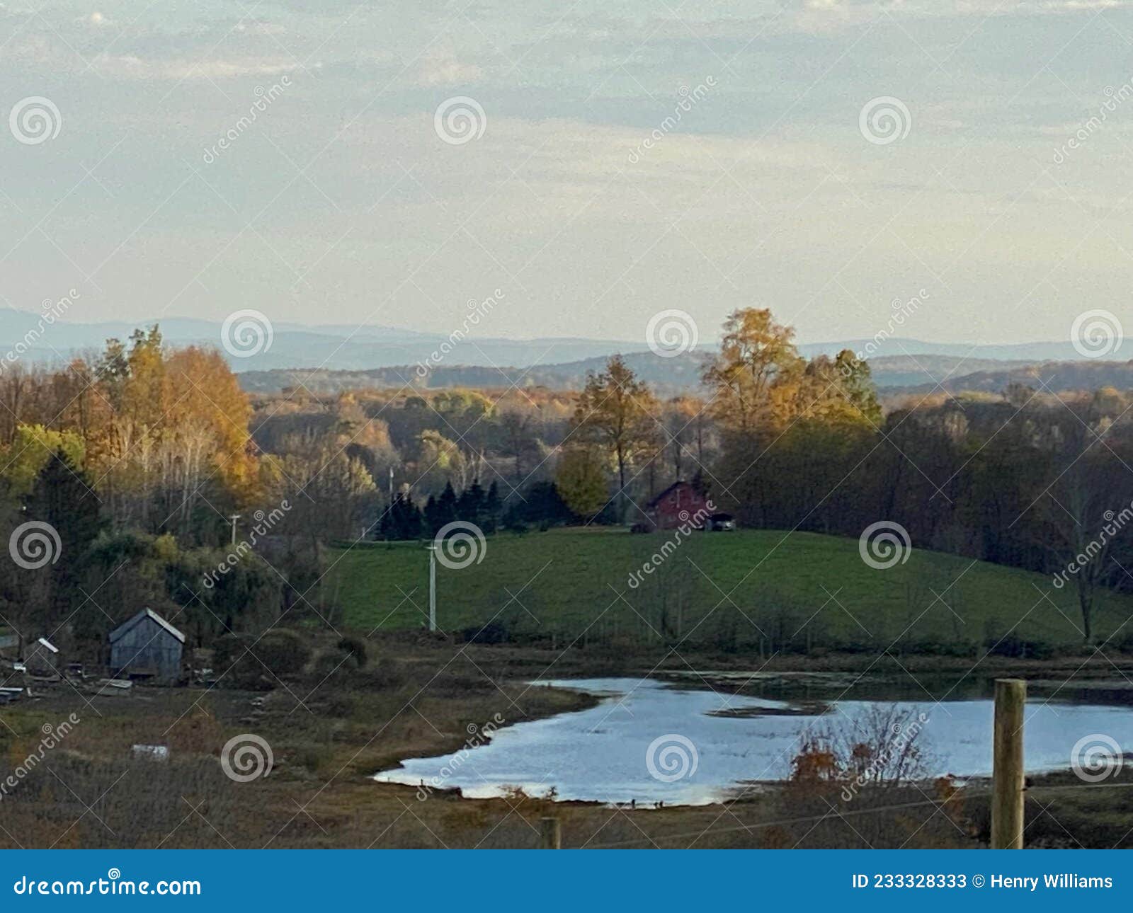 Farm in Upstate NY with Pond and Mountains in the Background Stock