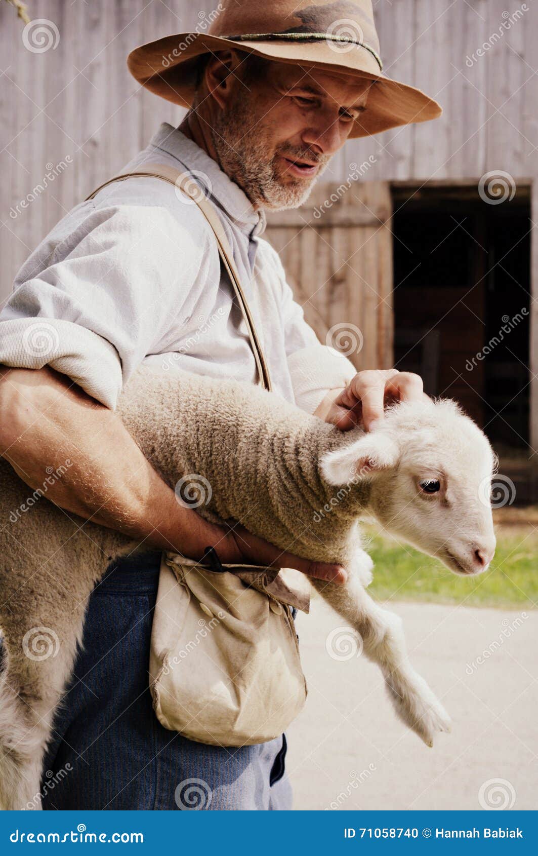 Farmer Holding Baby Lamb editorial image. Image of springtime 71058740