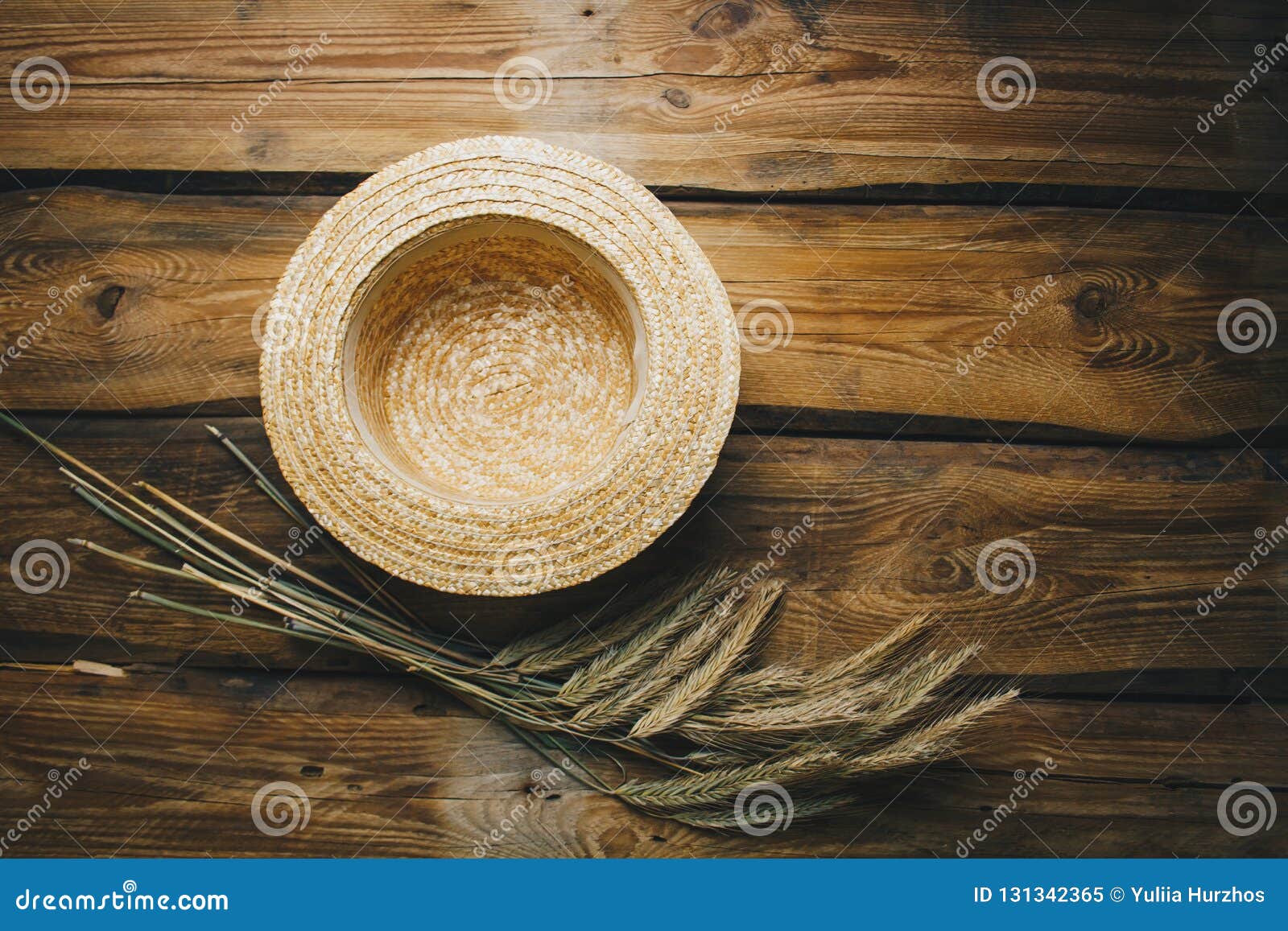 farmhouse vintage table with straw hat and spikelets of wheat. autumn, summer top view with copy space. flat lay for lettering, te