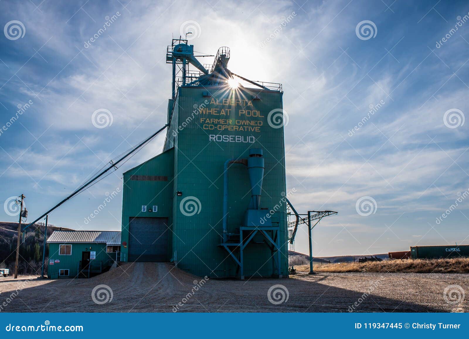 Grain Elevator in Prairies with Sun Peeking through Editorial Image