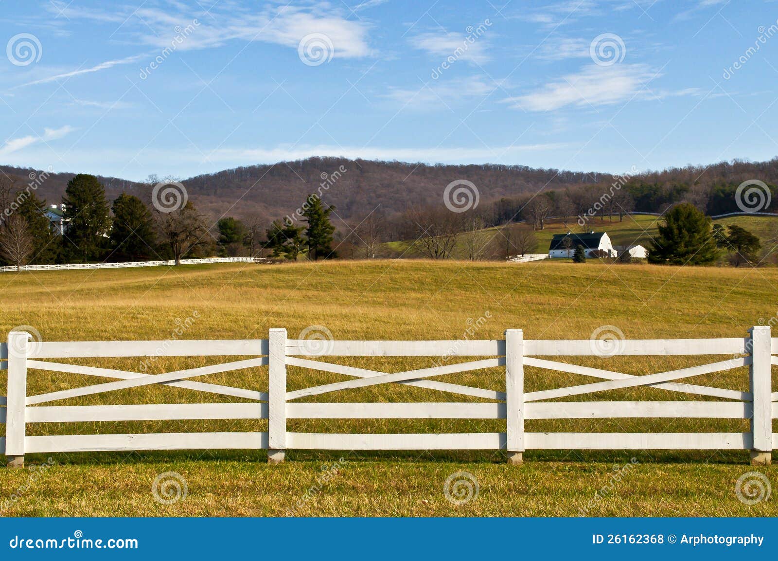 farmland with white fence foreground