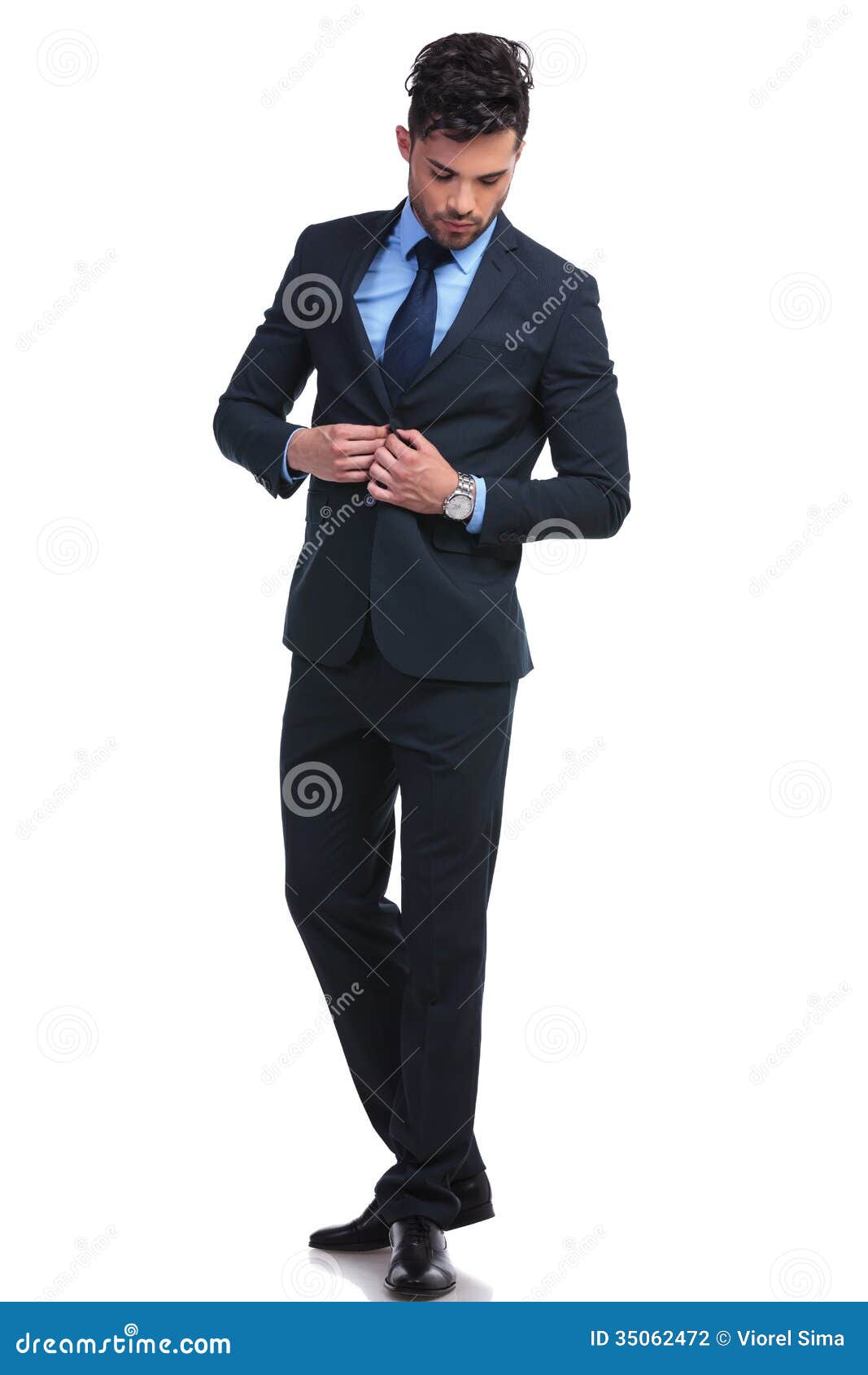 fashion business man un buttoning his suit looking down full length portrait 35062472
