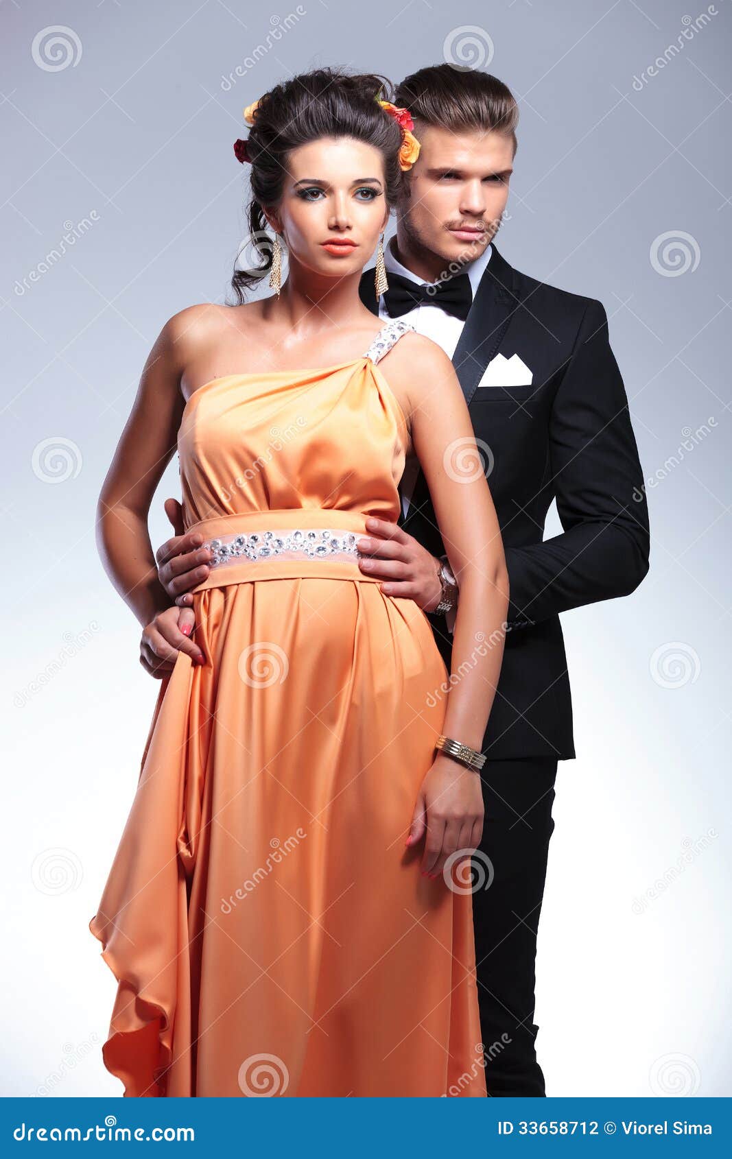 Fashion Couple With Man Behind, Looking Away Stock Photo 